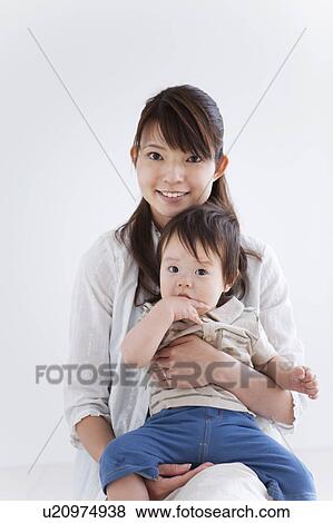 Stock Photo - Portrait of Young Mother and Baby Boy. Fotosearch