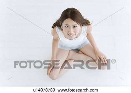 Stock Photo - Portrait of Young Woman, High Angle View. Fotosearch