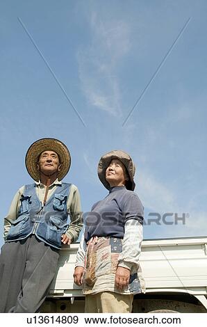 Stock Photo - Senior Couple and Truck Against Blue Sky. Fotosearch
