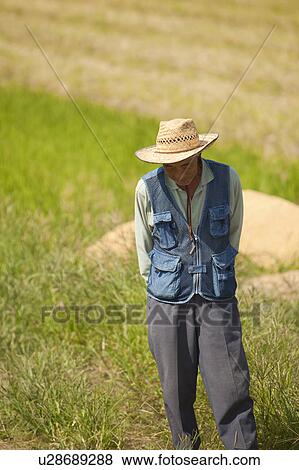 Stock Photo - Senior Farmer Standing in Field. Fotosearch