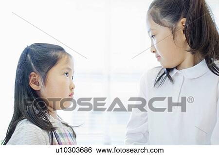 Sisters Looking At Each Other View Large Photo Image Stock Photograph - Sisters Looking At Each Other. Fotosearch