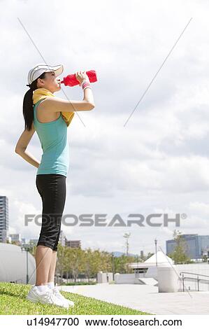 Stock Image - Sporty Young Woman Drinking From Water Bottle. Fotosearch