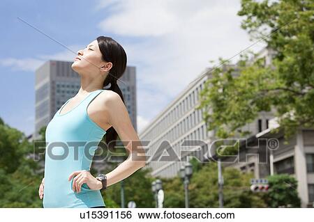 Stock Photograph - Sporty Young Woman with Hands On Hips. Fotosearch