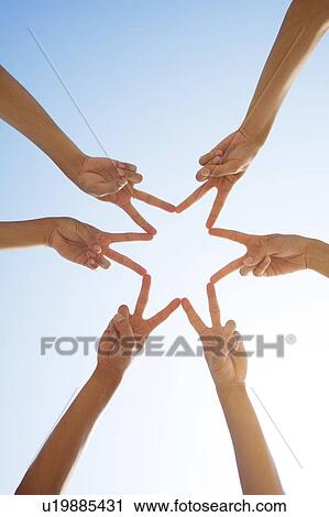 Stock Image - Three People Forming Star With Fingers. Fotosearch