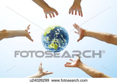 Stock Photo - Three People Reaching For Globe. Fotosearch