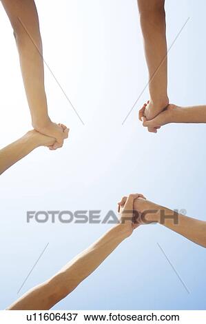 Three People's Holding Clasped Hands Up In Sky View Large Photo Image Stock Photo - Three People's Holding Clasped Hands Up In Sky. Fotosearch