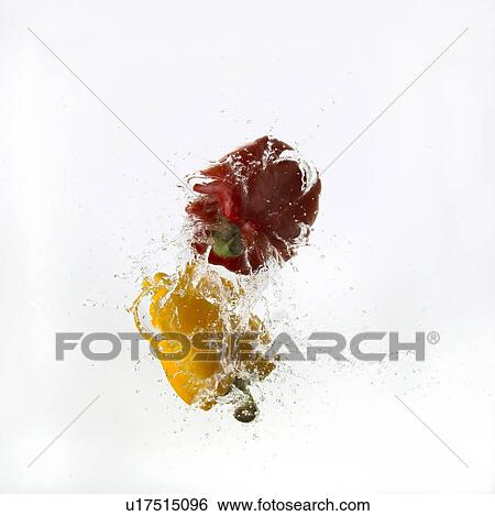 Stock Photograph - Two Bell Peppers Falling Into Water. Fotosearch