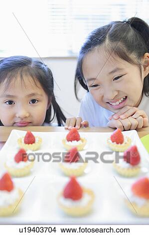Picture - Two Sisters and Strawberry Tarts. Fotosearch