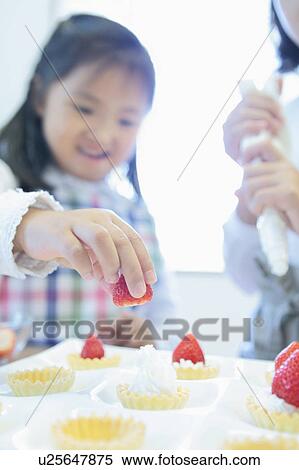 Two Sisters Making Strawberry Tarts View Large Photo Image Stock Photography - Two Sisters Making Strawberry Tarts. Fotosearch