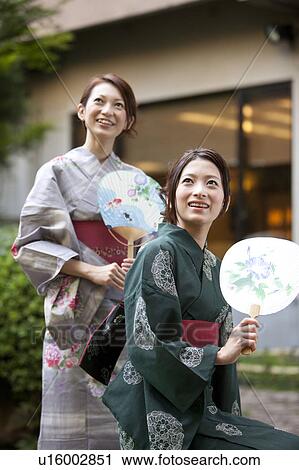Two Women in Yukata Holding Fans View Large Photo Image Stock Image - Two Women in Yukata Holding Fans. Fotosearch
