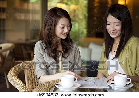 Stock Image - Two Young Women Having Coffee. Fotosearch