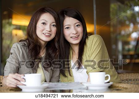 Two Young Women Having Coffee View Large Photo Image Stock Image - Two Young Women Having Coffee. Fotosearch