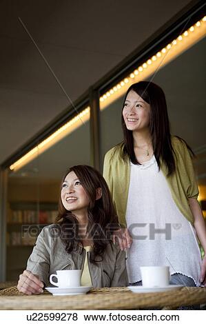 Two Young Women Having Coffee View Large Photo Image Stock Photo - Two Young Women Having Coffee. Fotosearch
