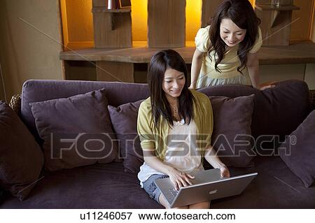 Stock Photo - Two Young Women Using Laptop. Fotosearch