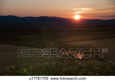 Stock Photography - Van driving up a hill in dusk, Hokkaido Prefecture, Japan. Fotosearch
