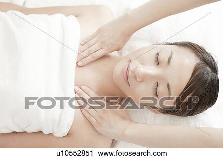 Stock Image - Woman getting a massage, Tokyo Prefecture, Japan. Fotosearch