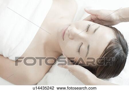 Stock Image - Woman getting a massage, Tokyo Prefecture, Japan. Fotosearch