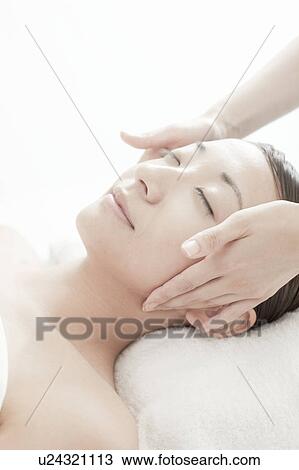 Stock Image - Woman getting a massage, Tokyo Prefecture, Japan. Fotosearch