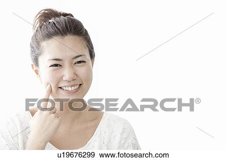 Woman touching her cheek with finger, Tokyo Prefecture, Honshu, Japan View Large Photo Image Stock Photo - Woman touching her cheek with finger, Tokyo Prefecture, Honshu, Japan. Fotosearch
