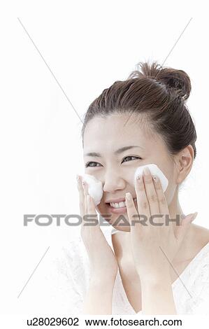 Stock Image - Woman washing her face, Tokyo Prefecture, Honshu, Japan. Fotosearch