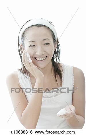 Stock Photograph - Woman washing her face, Tokyo Prefecture, Japan. Fotosearch