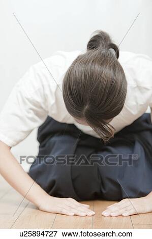 Stock Photo - Woman wearing Kyudo (Japanese art of archery) uniform bowing, Tokyo Prefecture, Japan. Fotosearch
