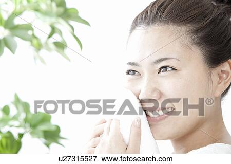 Woman wiping her face with towel, Tokyo Prefecture, Honshu, Japan View Large Photo Image Stock Photo - Woman wiping her face with towel, Tokyo Prefecture, Honshu, Japan. Fotosearch