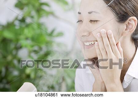 Woman with facial steamer, Tokyo Prefecture, Japan View Large Photo Image Stock Image - Woman with facial steamer, Tokyo Prefecture, Japan. Fotosearch