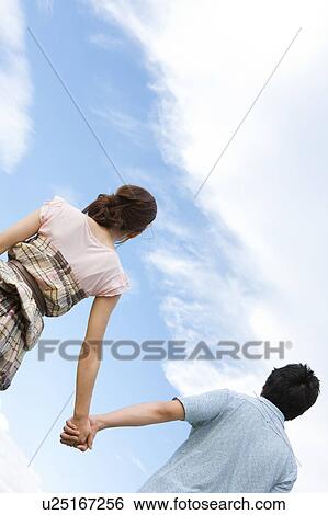 Young Couple Against Blue Sky View Large Photo Image Stock Photograph - Young Couple Against Blue Sky. Fotosearch