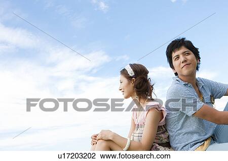 Stock Image - Young Couple Against Sky. Fotosearch