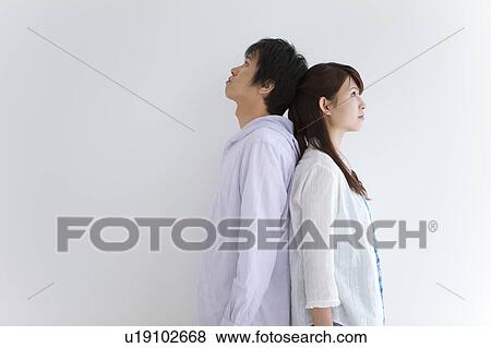 Young Couple Back to Back View Large Photo Image Stock Photo - Young Couple Back to Back. Fotosearch