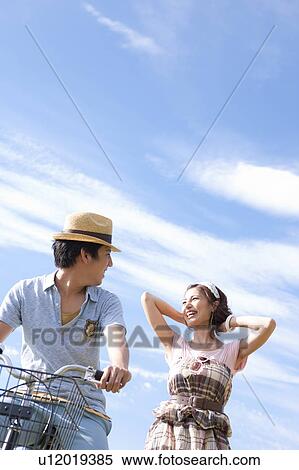 Young Couple Looking at Each Other, Boyfriend on Bike View Large Photo Image Stock Photography - Young Couple Looking at Each Other, Boyfriend on Bike. Fotosearch