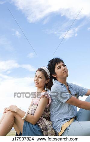 Young Couple Sitting Back To Back View Large Photo Image Picture - Young Couple Sitting Back To Back. Fotosearch