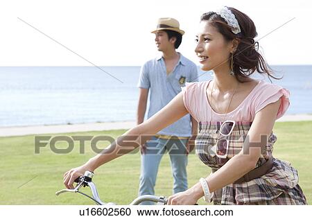 Stock Image - Young Couple with Bicycle. Fotosearch