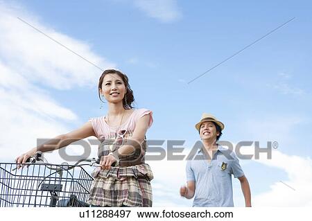 Stock Photo - Young Couple with Bicycle. Fotosearch