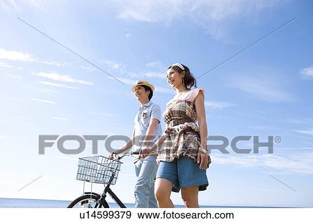 Stock Photo - Young Couple with Bicycle. Fotosearch