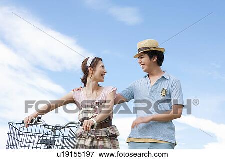 Stock Photo - Young Couple With Bicycle. Fotosearch
