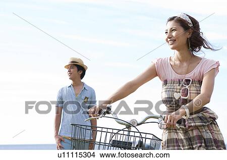 Young Couple with Bike View Large Photo Image Picture - Young Couple with Bike. Fotosearch