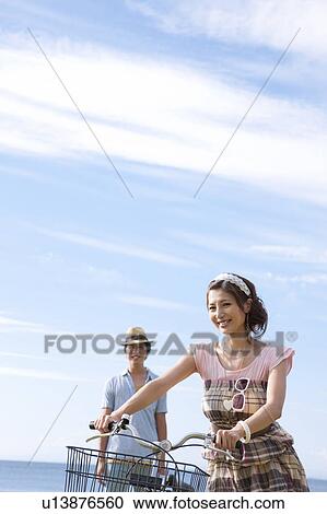 Stock Image - Young Couple with Bike. Fotosearch
