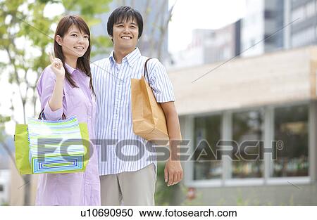 Young Couple with Shopping Bags View Large Photo Image Stock Image - Young Couple with Shopping Bags. Fotosearch