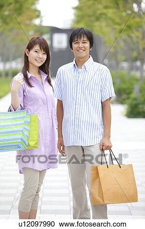 Stock Image - Young Couple with Shopping Bags. Fotosearch