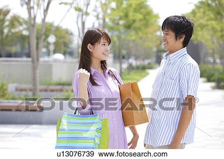 Stock Photo - Young Couple with Shopping Bags. Fotosearch