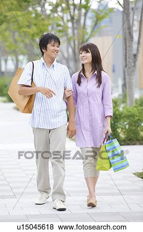 Young Couple with Shopping Bags Walking View Large Photo Image Stock Photo - Young Couple with Shopping Bags Walking. Fotosearch