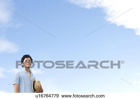 Stock Photo - Young Man Against Blue Sky. Fotosearch