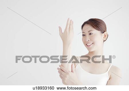 Stock Image - Young Woman and Hand Care. Fotosearch
