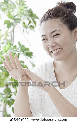 Young woman applying moisturizer on hand, Tokyo Prefecture, Honshu, Japan View Large Photo Image Stock Image - Young woman applying moisturizer on hand, Tokyo Prefecture, Honshu, Japan. Fotosearch