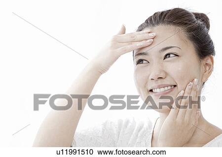 Young woman applying moisturizer on face, Tokyo Prefecture, Honshu, Japan View Large Photo Image Stock Image - Young woman applying moisturizer on face, Tokyo Prefecture, Honshu, Japan. Fotosearch