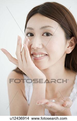 Young Woman Applying Moisturizer View Large Photo Image Picture - Young Woman Applying Moisturizer. Fotosearch