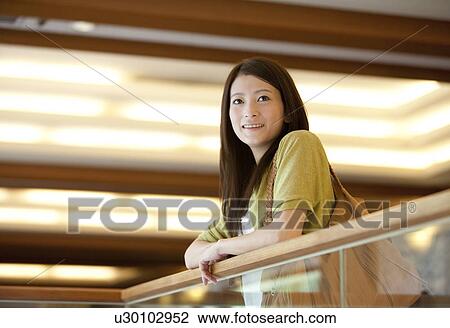 Stock Image - Young Woman by Railing. Fotosearch