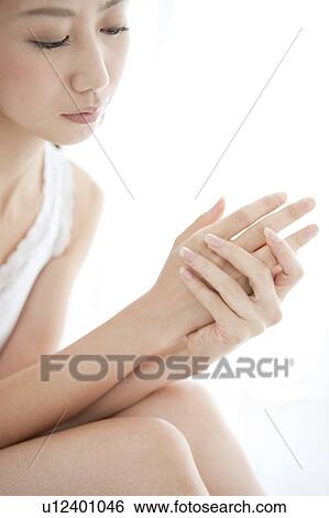 Stock Photograph - Young Woman Caring Her Hands. Fotosearch